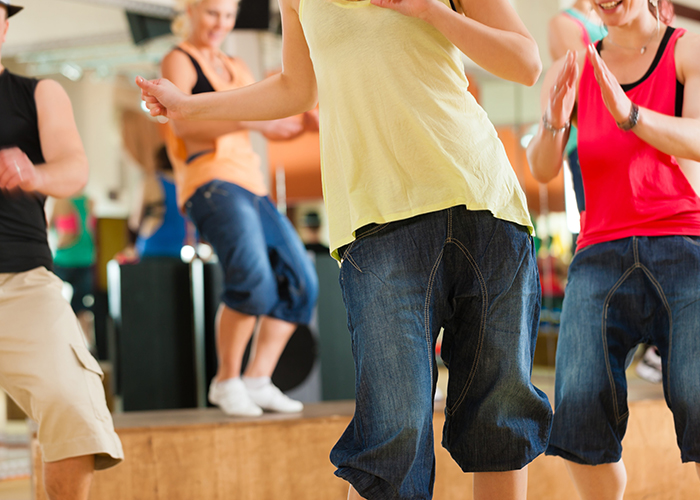 Zumba or Jazzdance - young people dancing in a studio or gym doing sports or practicing a dance number